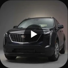 2019 Cadillac XT4 Luxury in black, front three-quarter view in a grey studio, the cover of a reel.