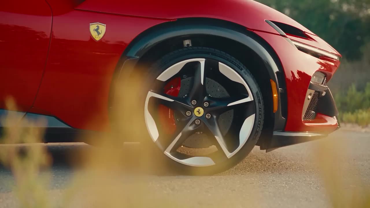 A cinematic film of a red Ferrari Purosangue, front wheel and side in low golden light, made with StudioOS from photos of the car.